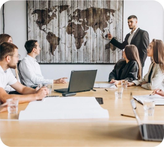 Presenter leading a marketing strategy meeting in front of a world map