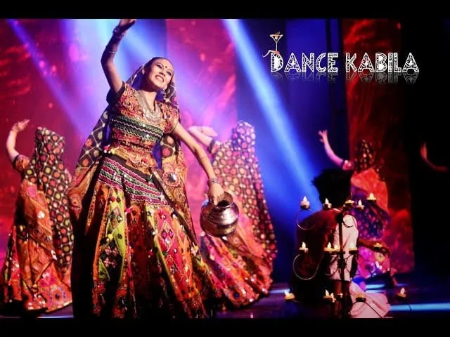 Dance Kabila performers in traditional dress on stage