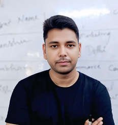 Shanu Quraishi, founder of Search Extension, standing in front of a whiteboard