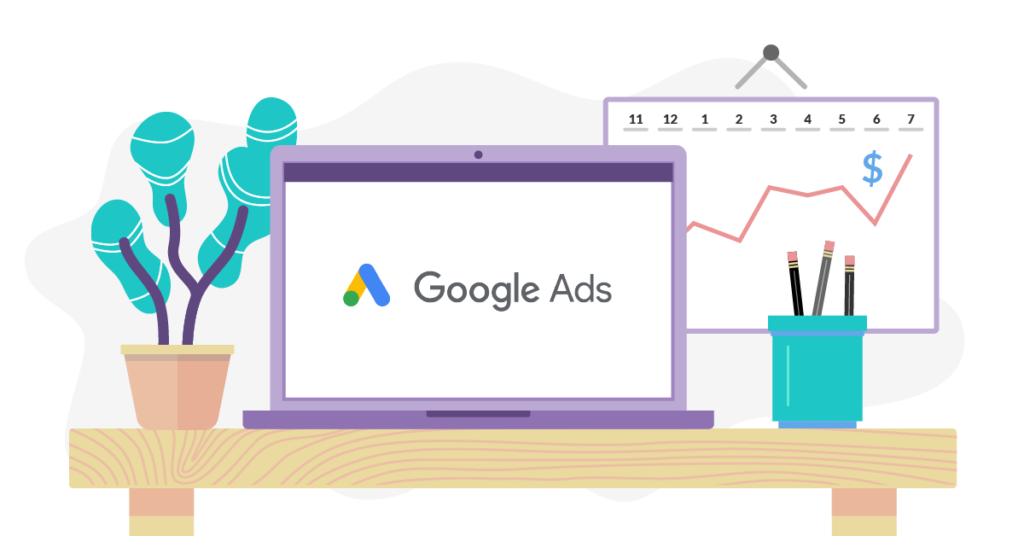 Laptop showing Google Ads on a desk next to a rising graph