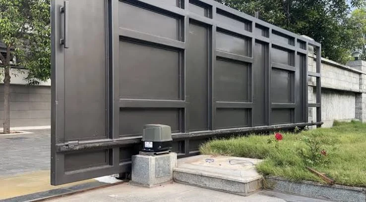 Automatic sliding gate with its gate motor installed on a concrete base